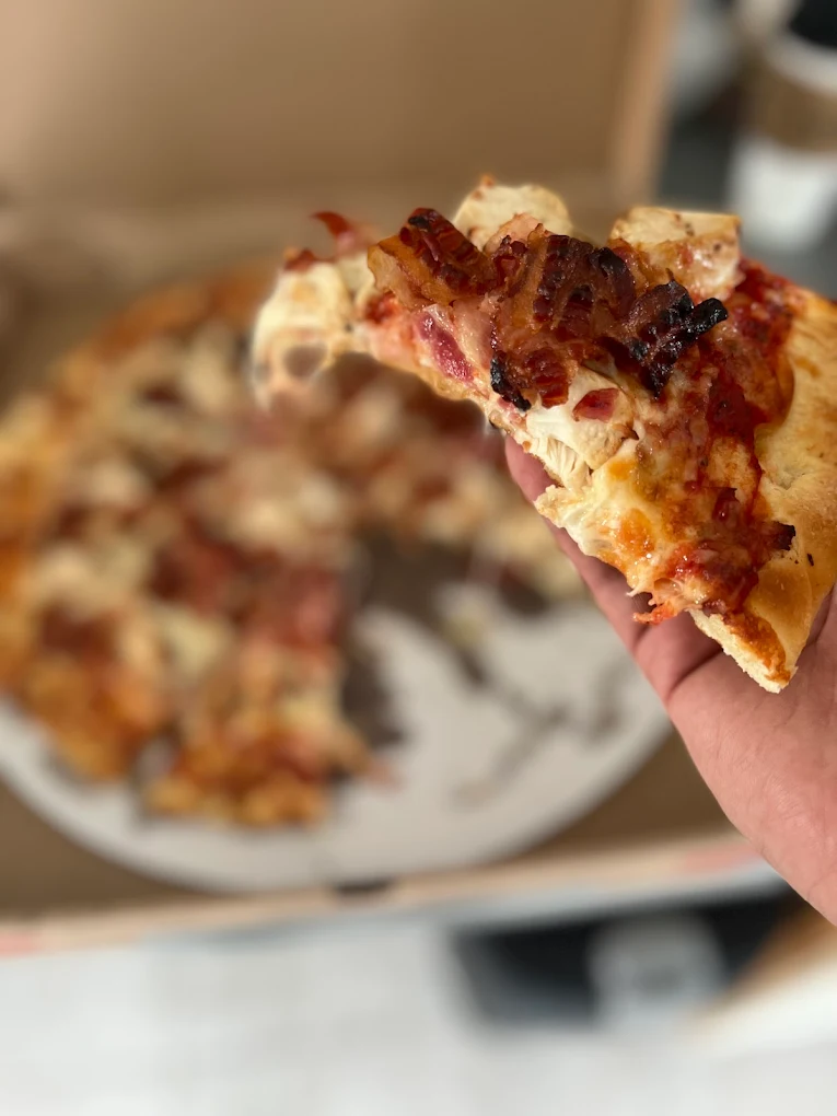 Bacon and meat pizza slice